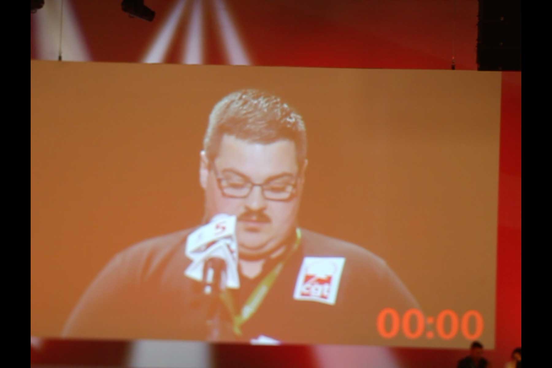 Der Gewerkschafter Tenessee Garcia liest seine Eingabe am Mikrophon vor  Fotografie von Heiko Schäfer