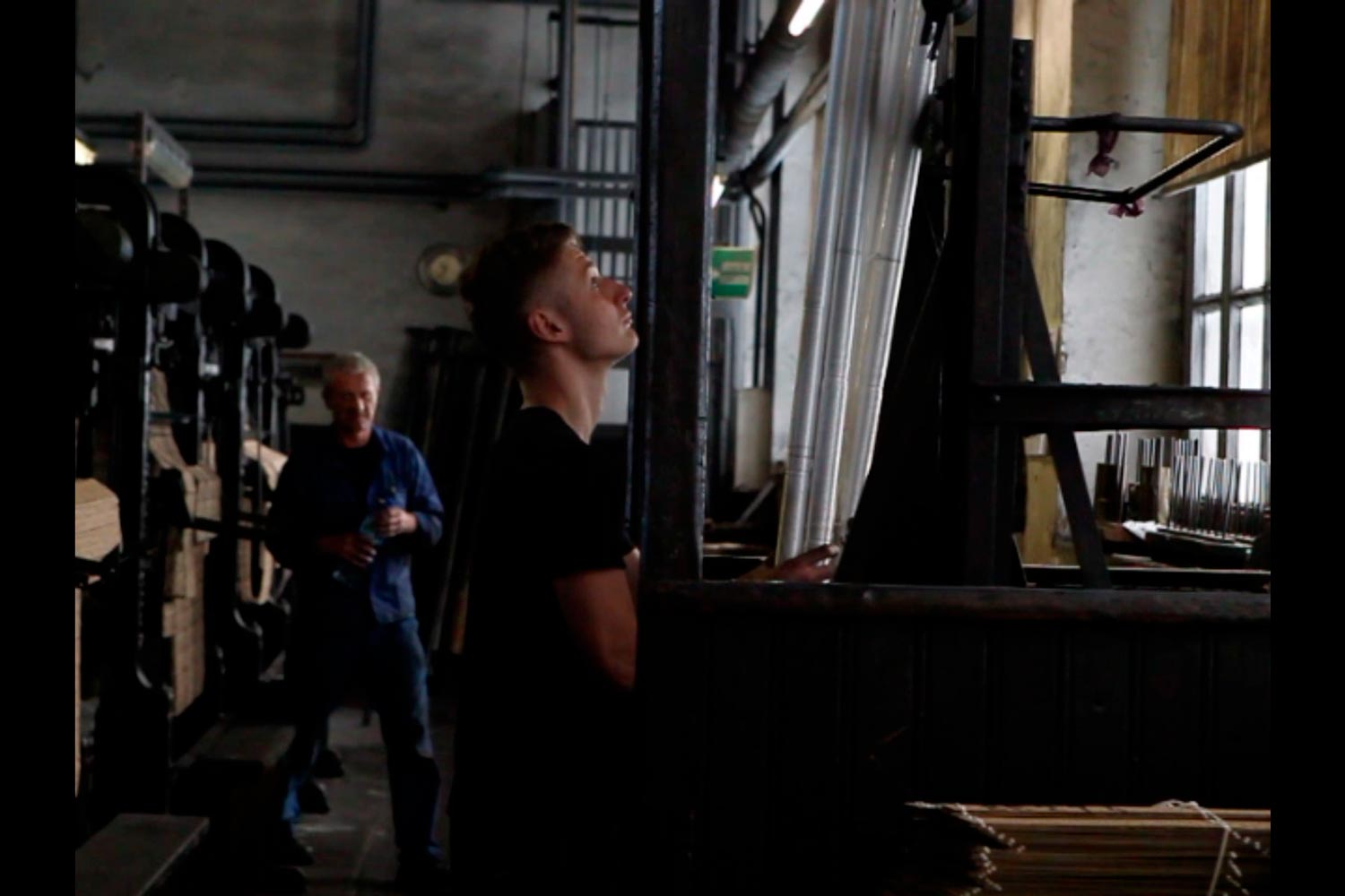 Der junge Textilarbeiter Matthieu am Aufzug in der Textilfirma Codentel  Fotografie von Heiko Schäfer