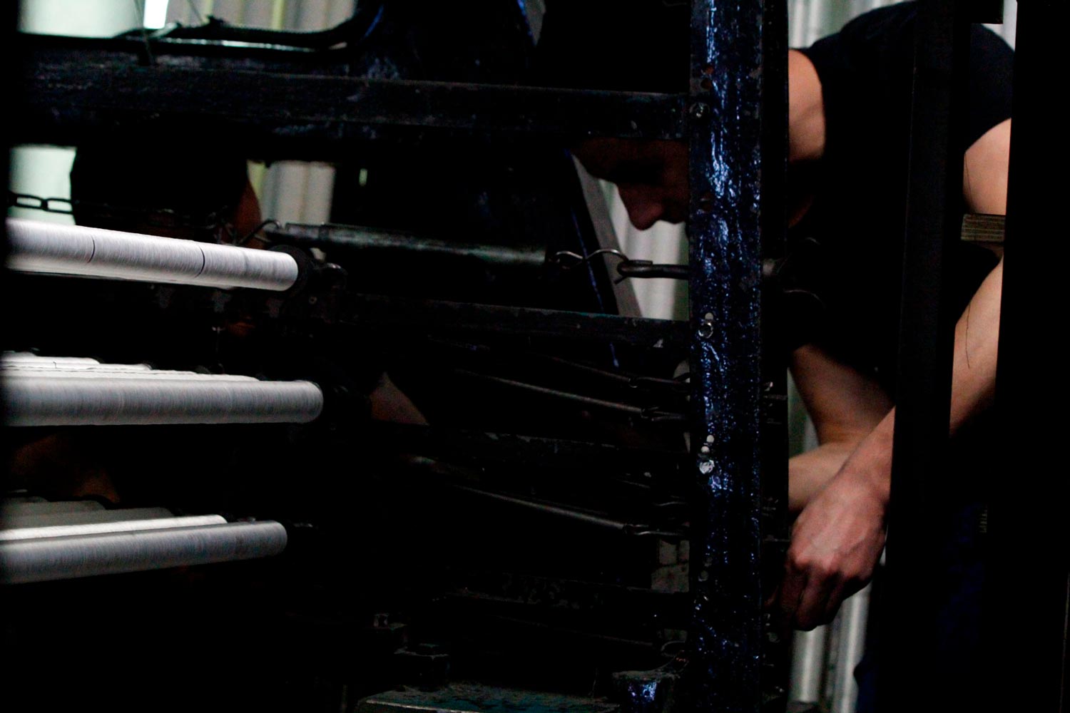 Der junge Arbeiter Matthieu arbeitet mit seinem Vater am Leavers Webstuhl in der Textilfabrik Codentel  Fotografie von Heiko Schäfer