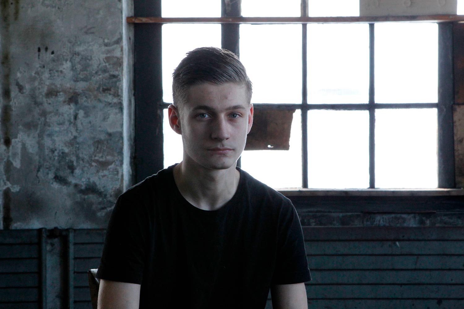 Der junge Arbeiter Matthieu im Interview in einer Halle der Textilfirma Codentel  Fotografie von Heiko Schäfer