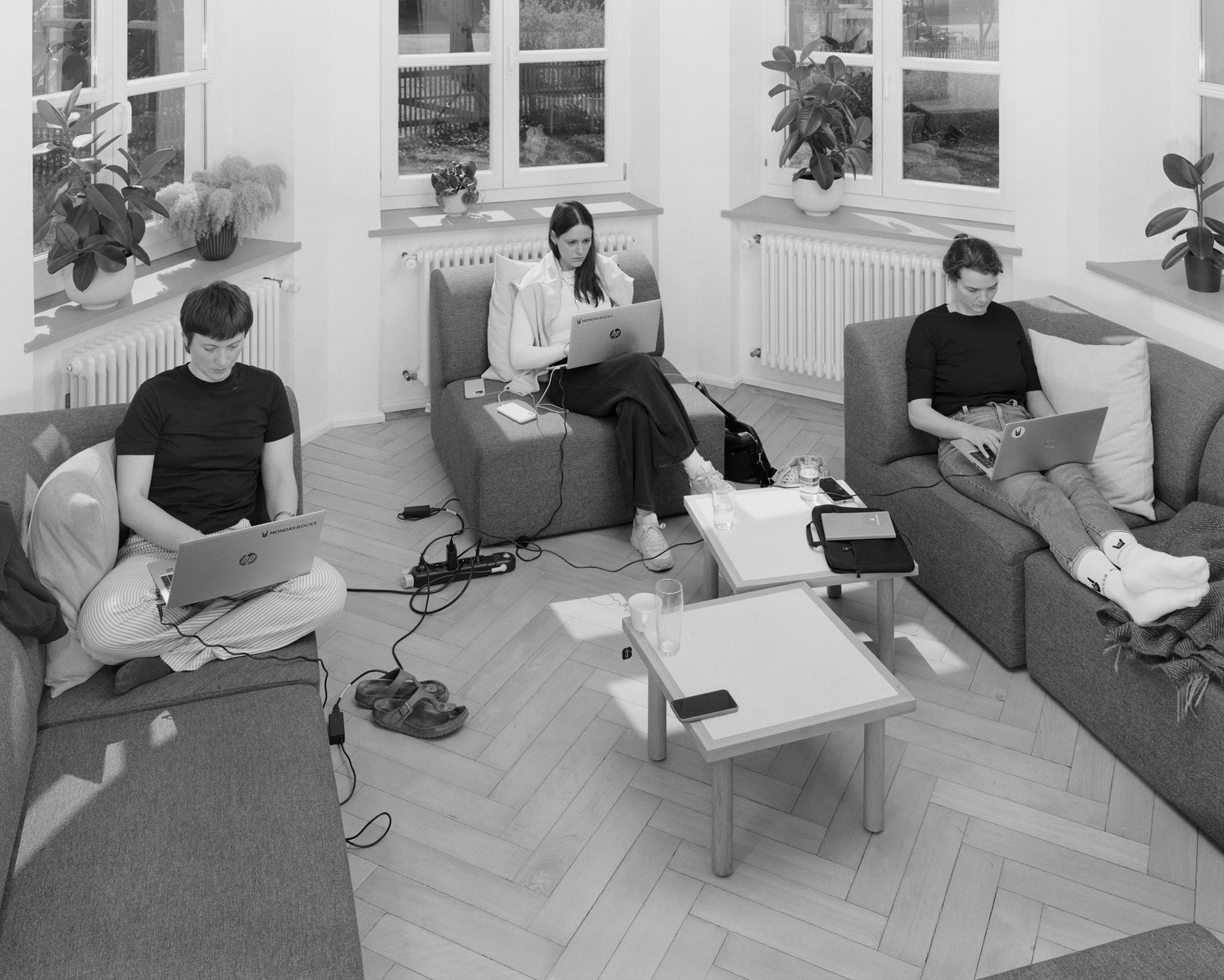 Drei Angestellte eines Startups arbeiten während einer Workation an ihren Laptops  Fotografie von Heiko Schäfer